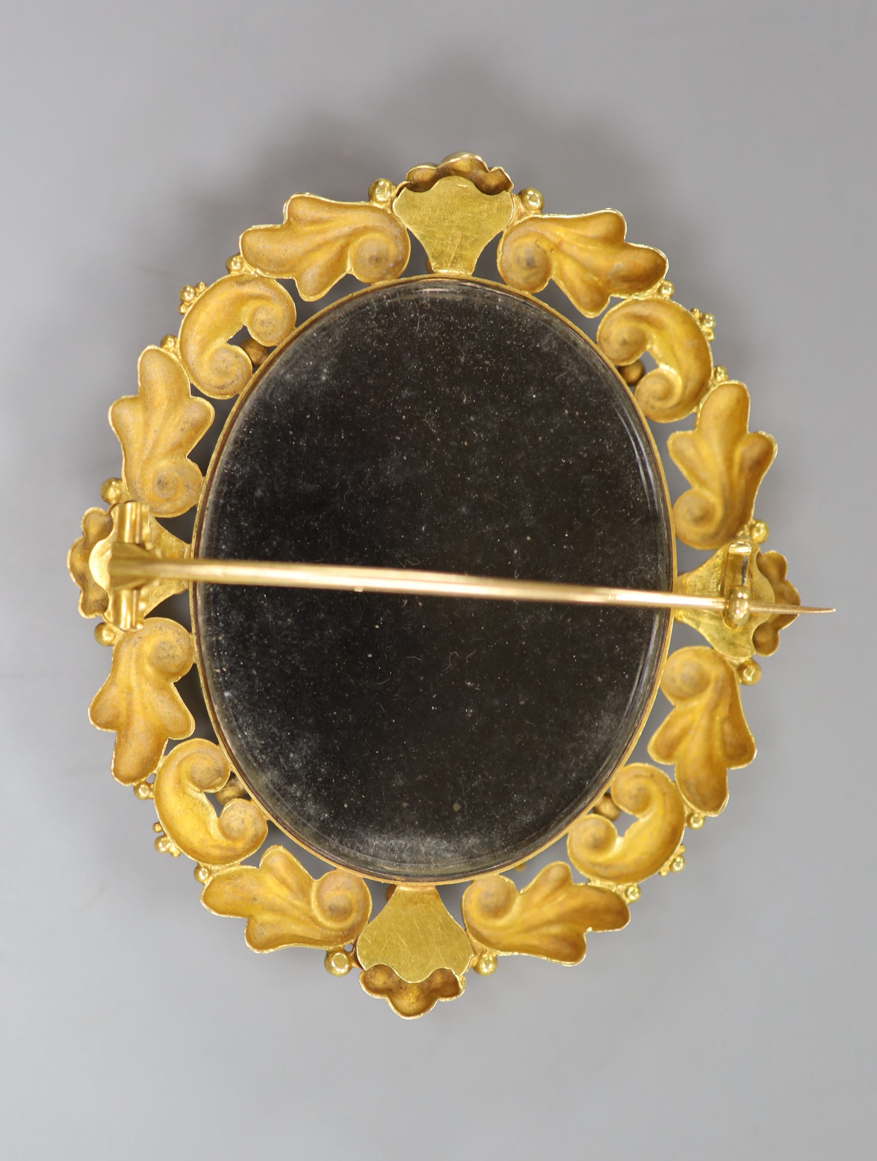 A yellow metal mounted carved mother of pearl cameo oval brooch, 59mm, gross 27.8 grams.